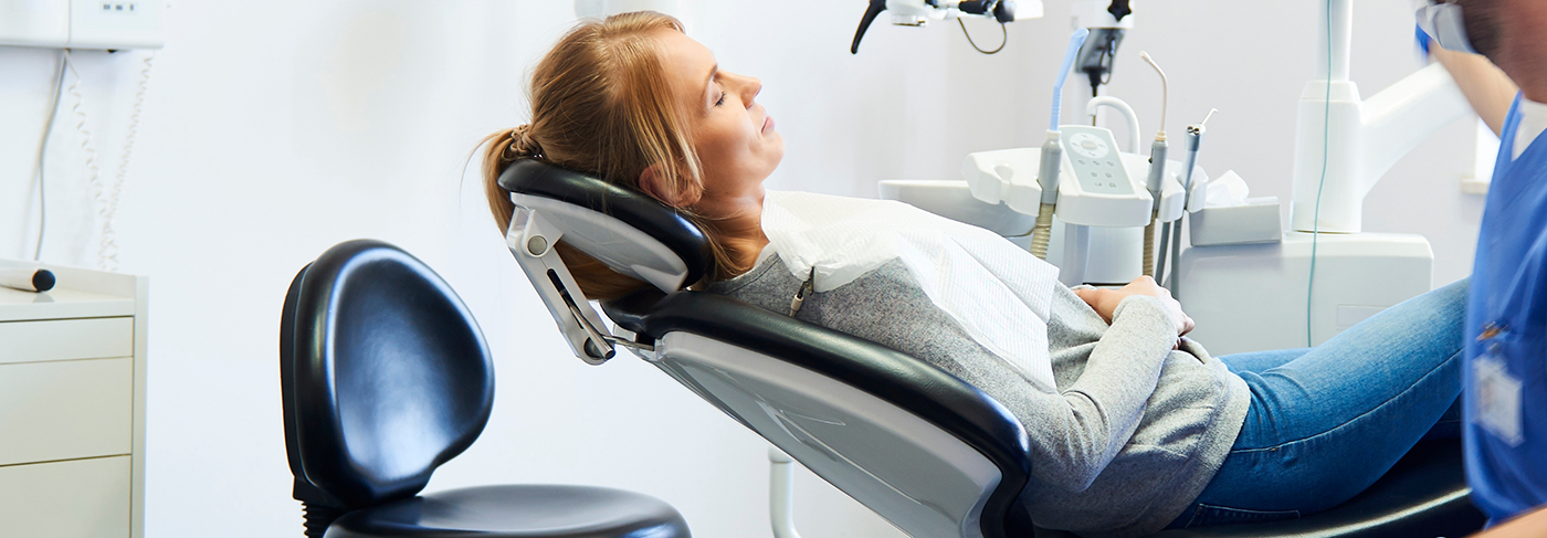 Woman laying in dental chair before getting dental sealants in Londonderry