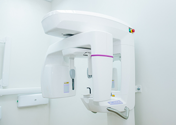 Panoramic dental x ray device standing against white wall