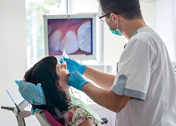 Dentist capturing photos of a patients teeth during exam