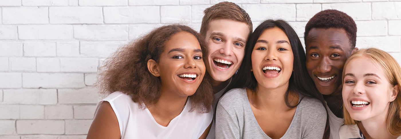 Group of young adults smiling with Invisalign in Londonderry