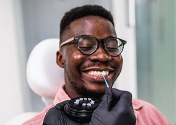 Dental patient grinning while receiving Lumineers