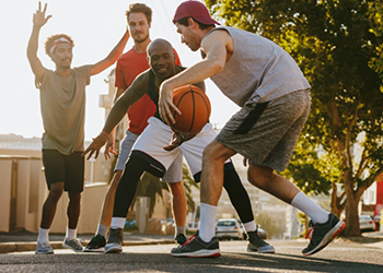 Group of young men playing basketball