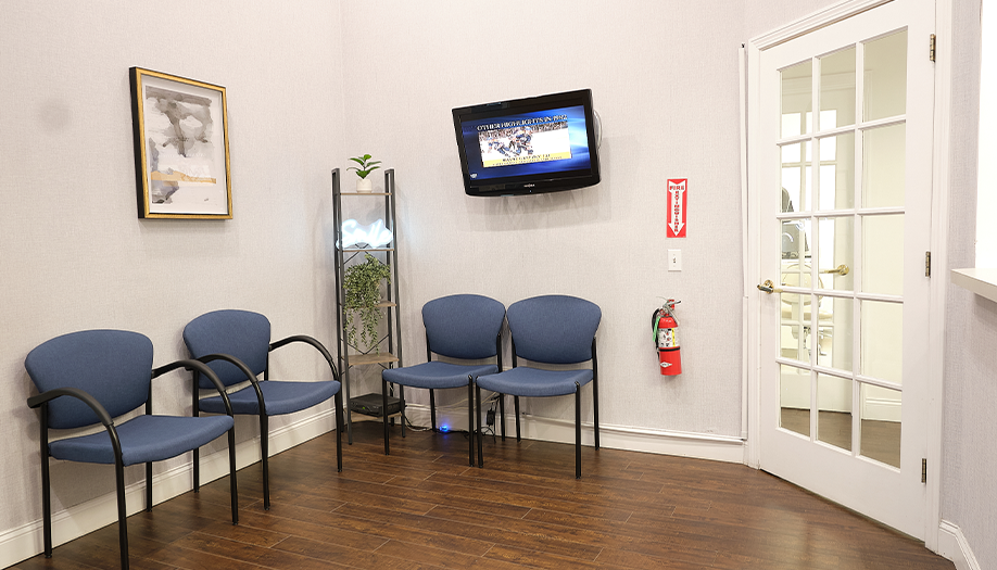 Four blue chairs in waiting area