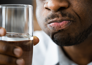 Man drinking from glass of water