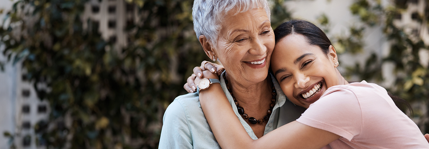 Two women hugging and smiling with veneers in Londonderry